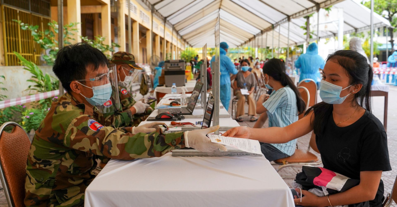 Binh sĩ kiểm tra giấy tờ của người đến chích vắc xin Covid-19 tại Campuchia /// Reuters 