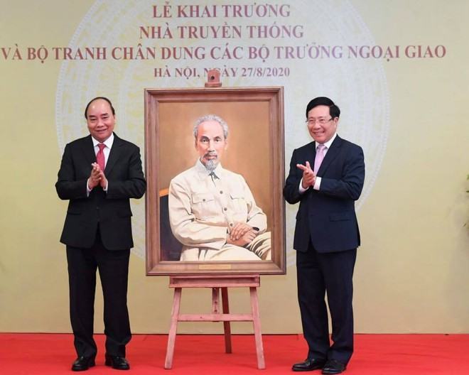 Thủ tướng Nguyễn Xuân Phúc và Phó thủ tướng - Bộ trưởng Ngoại giao Phạm Bình Minh bên bức tranh chân dung Chủ tịch Hồ Chí Minh (họa sĩ Lê Anh Vân) /// ẢNH: BTC