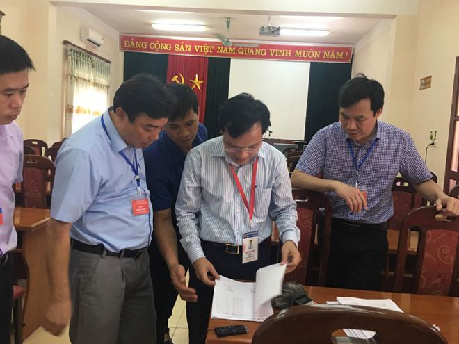 Ông Mai Văn Trinh (giữa) kiểm tra điểm chênh giữa vòng 1 và vòng 2 ở tổ chấm thi tự luận Sở GD-ĐT Bắc Kạn  /// QUÝ HIÊN